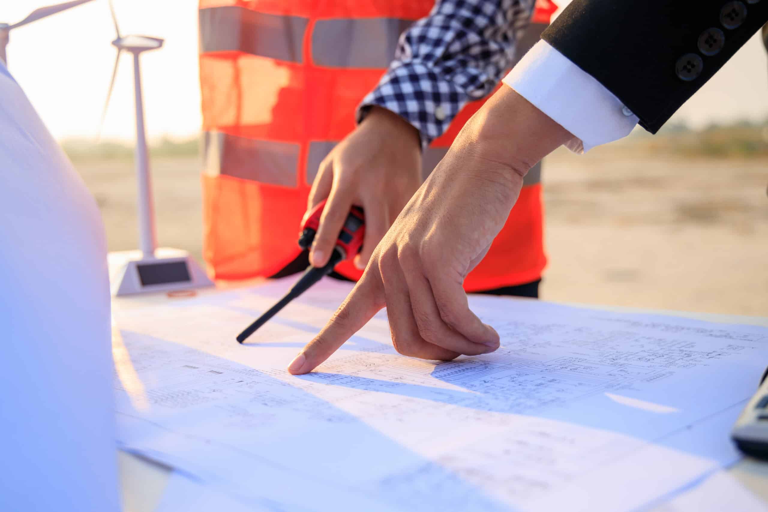 Meeting of engineers on outdoor construction site