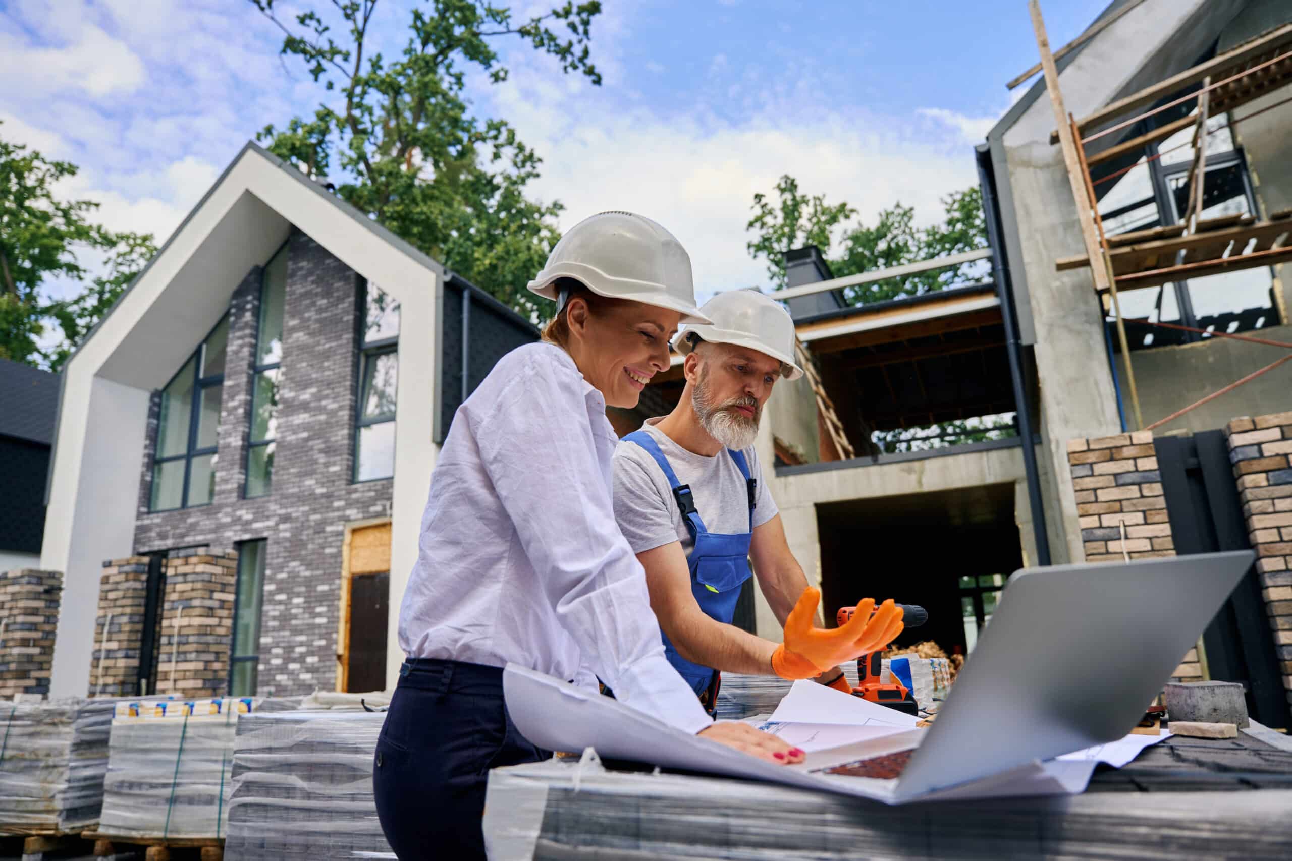 homebuilders surety plays a pivotal role in construction projects. here is a project owner and contractor reviewing plans.